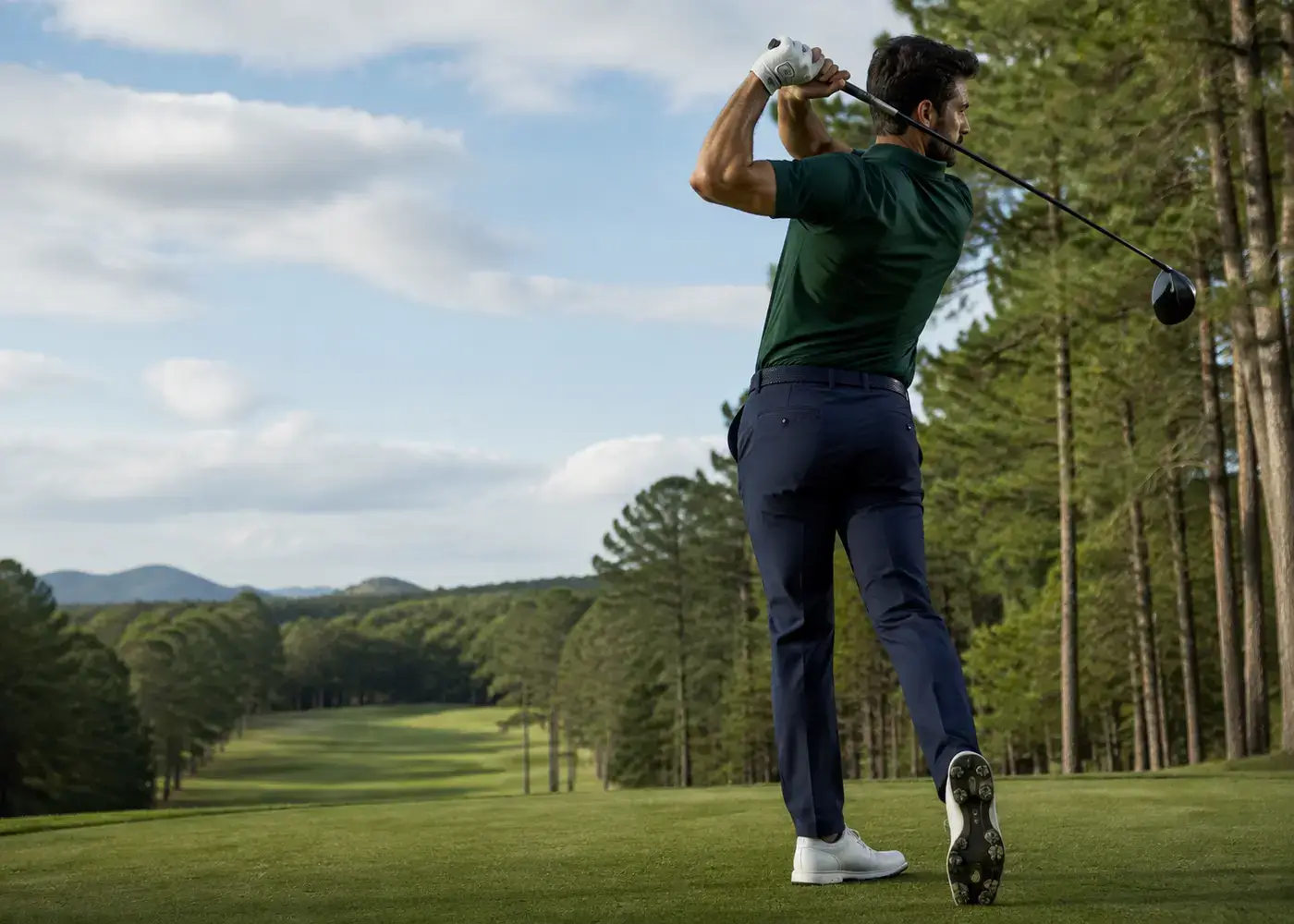 Golfer completing a full swing while testing golf apparel movement