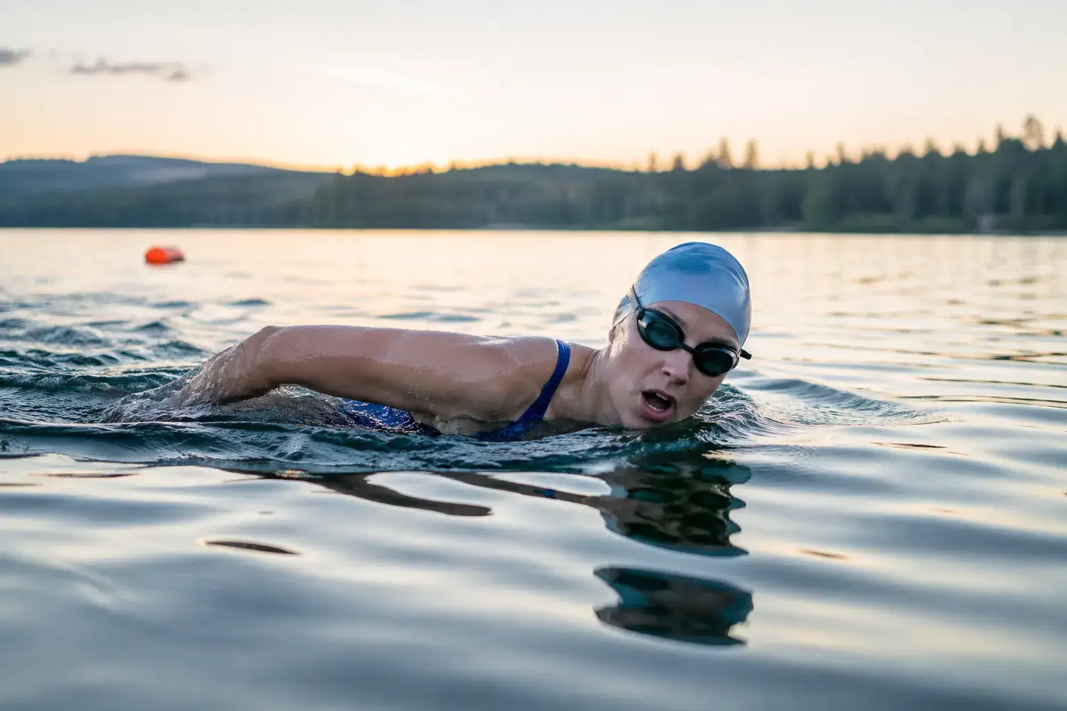 Open-water swimmer wearing custom swimming apparel while sighting ahead
